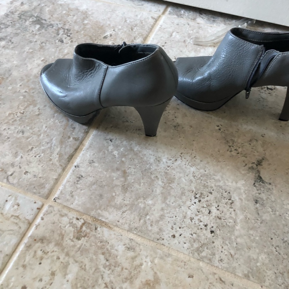 Grey leather four inch plate form heals worn once zippered on sides
